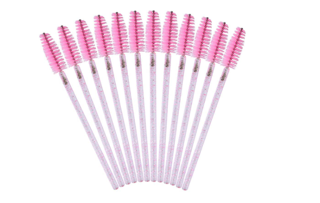 Set of eyelash brushes with pink bristles on.