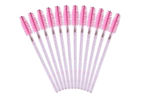 Set of eyelash brushes with pink bristles on.